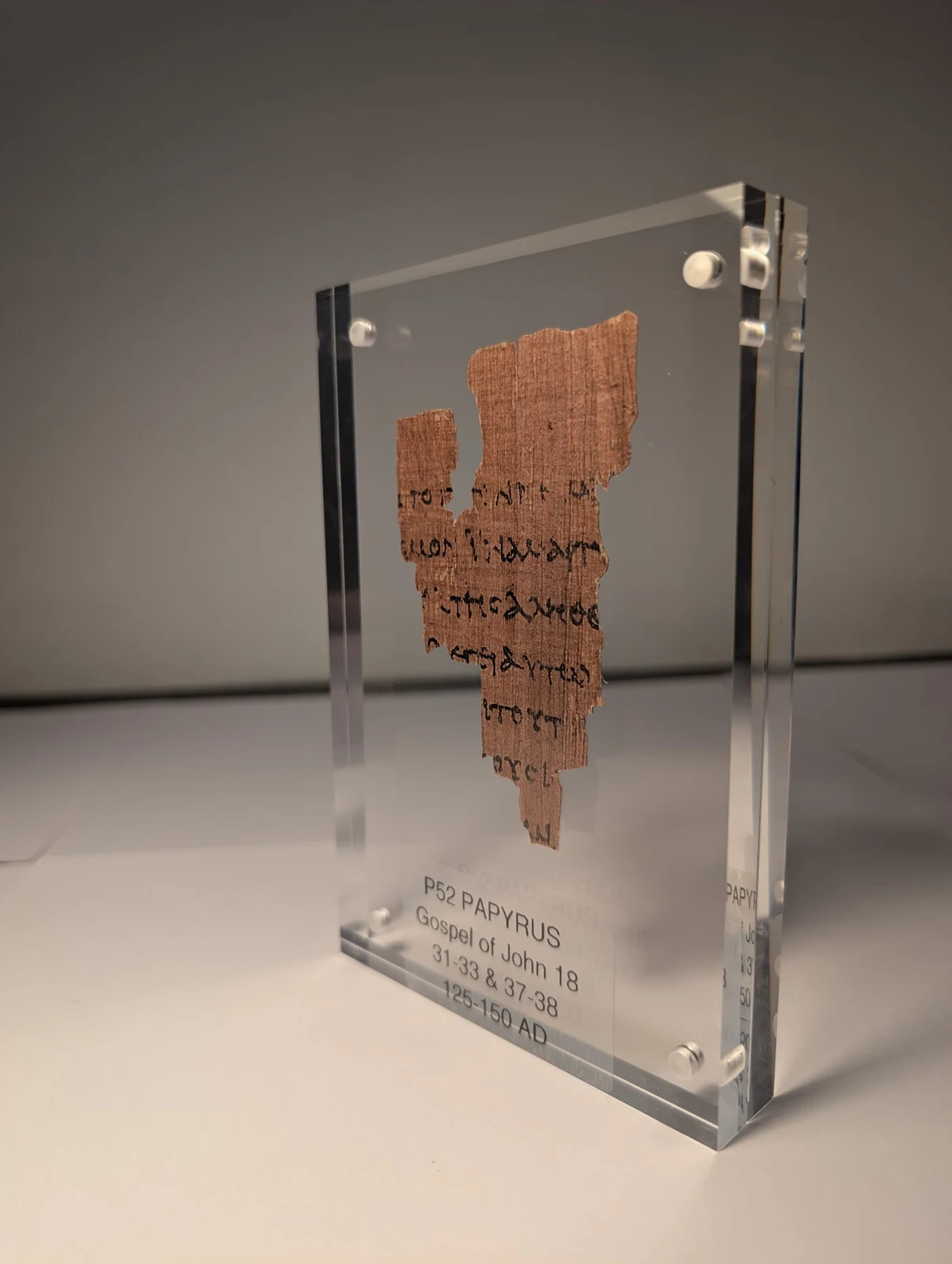 Rhys’s modern P52 papyrus replica displayed in a clear acrylic frame
